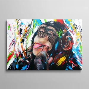 Tableau chimpanzé multicolore peinture éclaboussures doigt dans la bouche tire la langue